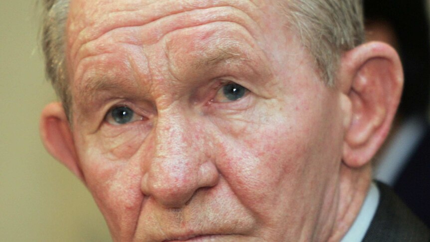 Charles Robert Jenkins looks past the camera to reporters in Japan in 2004