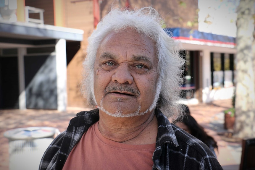 A portrait of an Aboriginal man with white hair