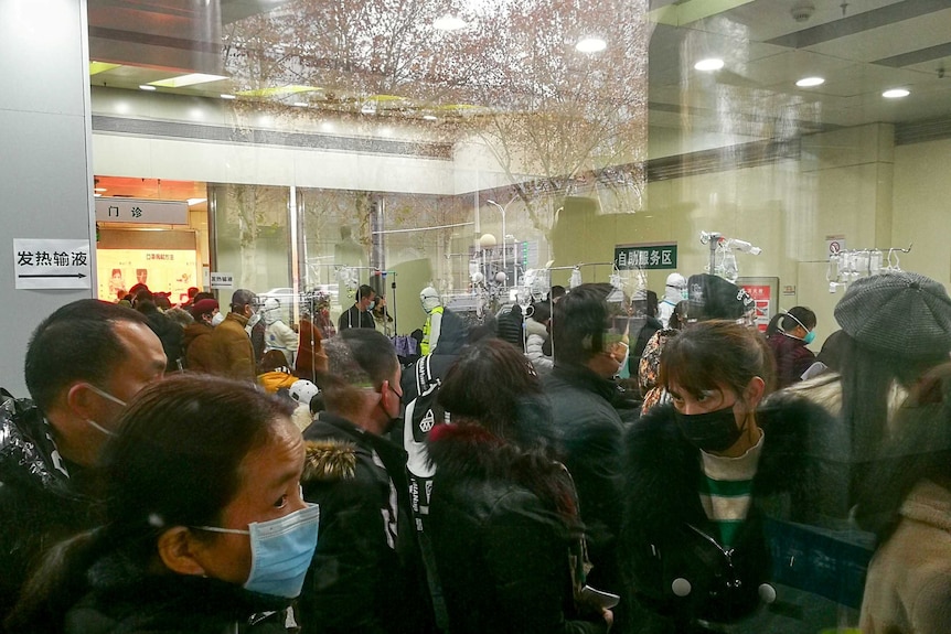 Large queue of people at a Wuhan hospital wearing masks