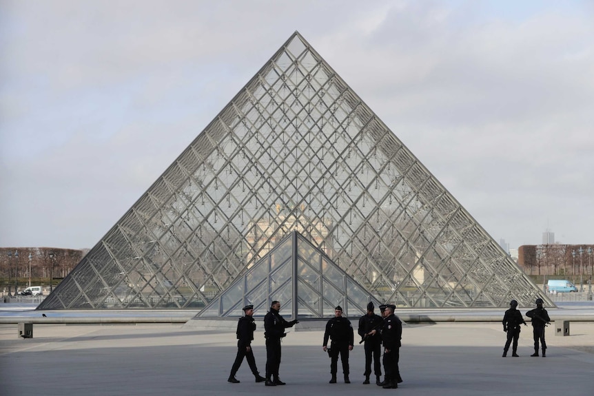 French police secure the site near the Louvre Pyramid in Paris