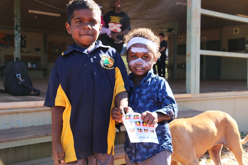 Two children stand together in Yarralin, a remote town in the NT