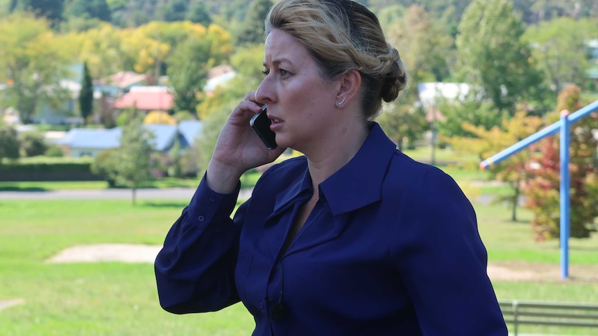 Detective Senior Constable Jane Prior speaking on the phone in a park.