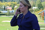 Detective Senior Constable Jane Prior speaking on the phone in a park.