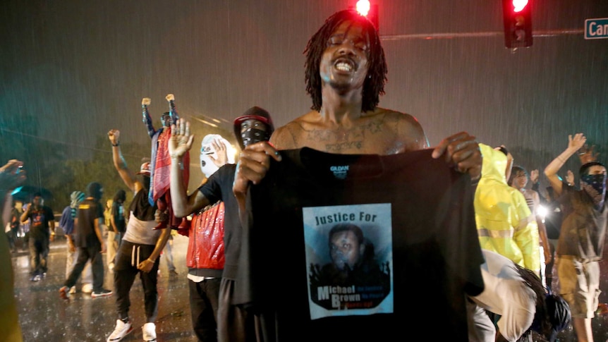 Ferguson protester holds up image of Michael Brown