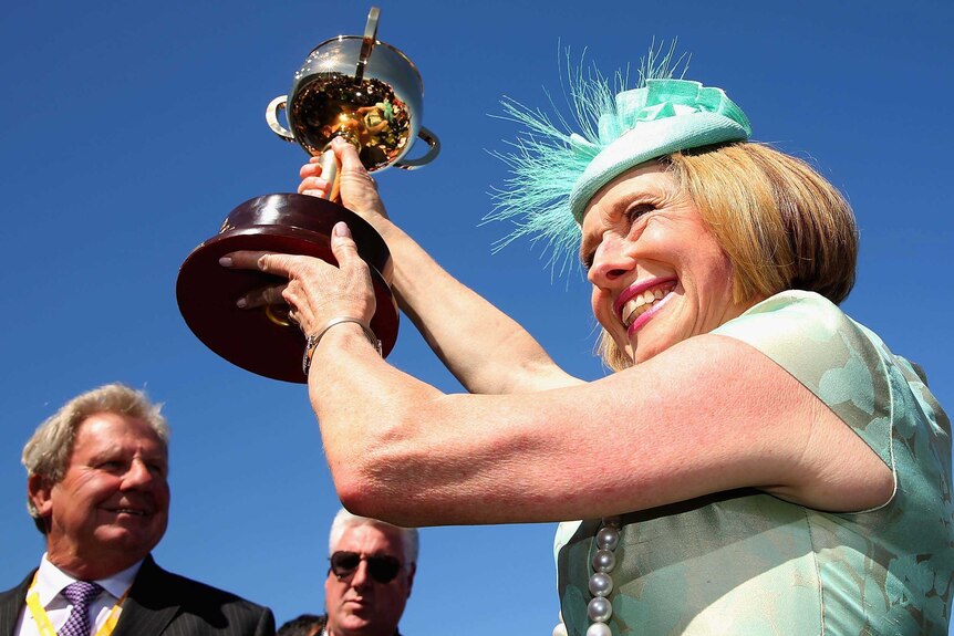 Winning trainer Gai Waterhouse holds the Melbourne Cup aloft