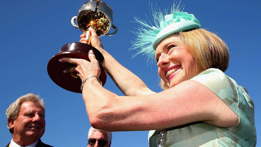 Winning trainer Gai Waterhouse holds the Melbourne Cup aloft