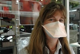 Brisbane woman with surgical mask.