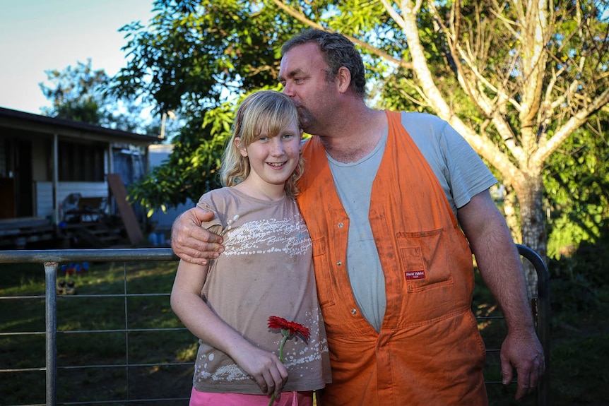 Andrew Humphreys kisses his daughter Paige on the head.