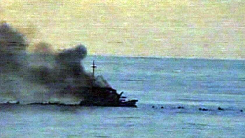 Defence still of asylum seeker boat on fire, can see bodies in water