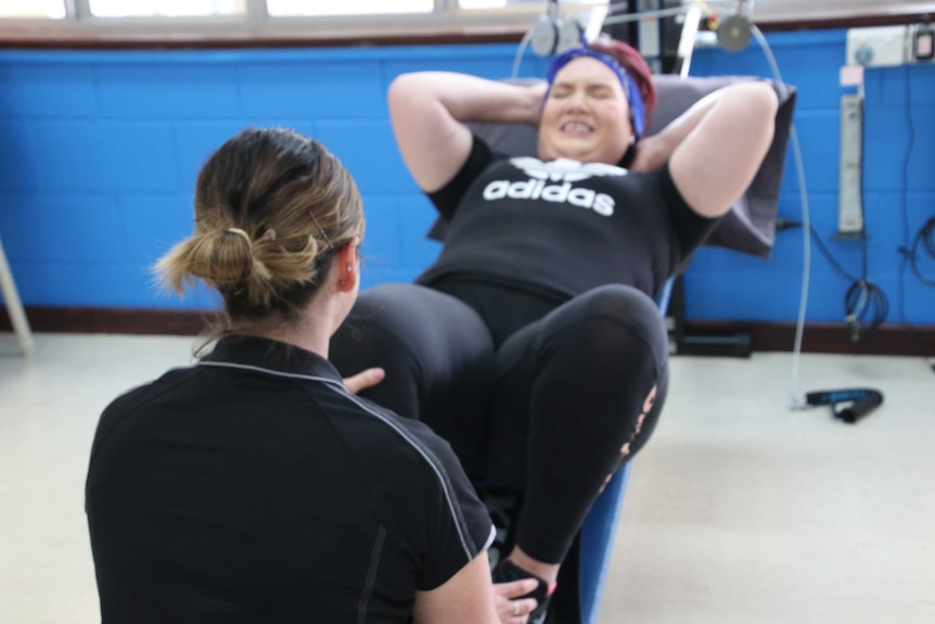 Ariana Pila grimaces during an exercise session.