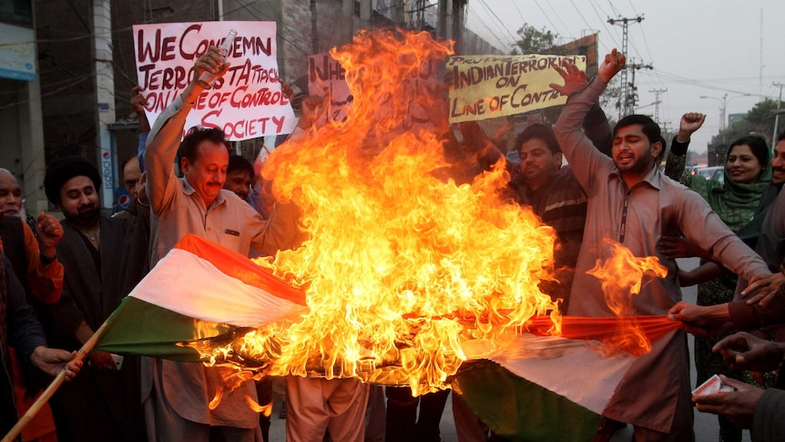 Pakistan protesters burn a representation of an Indian flag.