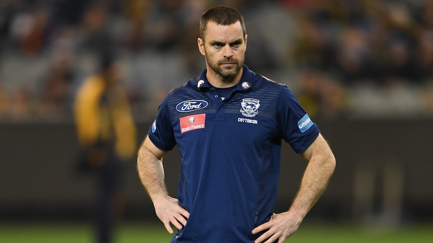 A Geelong AFL assistant coach stands out on the playing field at the MCG.