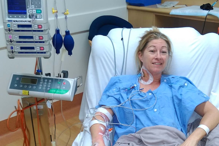 A woman recovering from surgery in a hospital bed