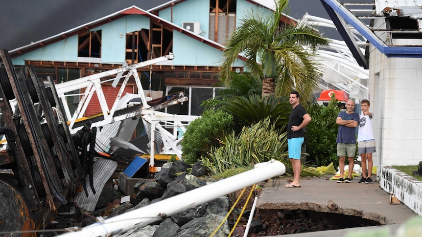 People look at the wrecked marina at Shute Harbour near Airlie Beach, destroyed by Cyclone Debbie
