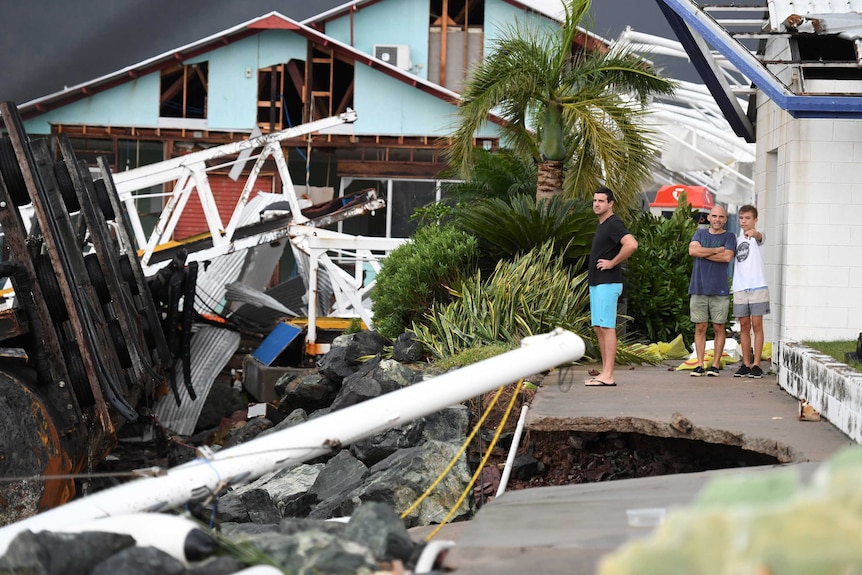 People look at the wrecked marina at Shute Harbour near Airlie Beach, destroyed by Cyclone Debbie