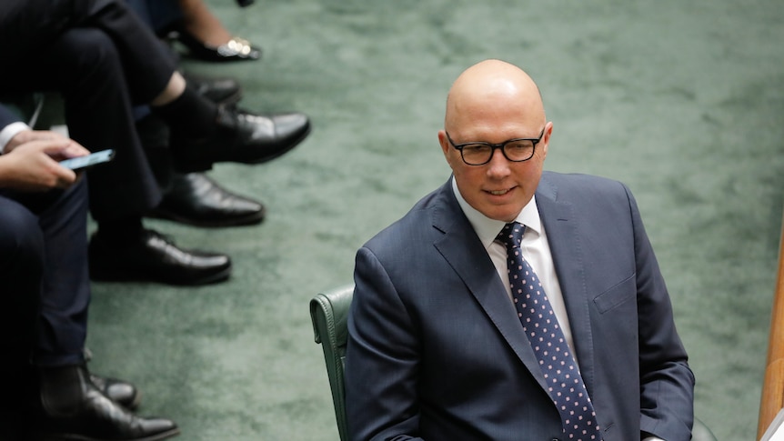 Peter Dutton sits in the House of Representatives