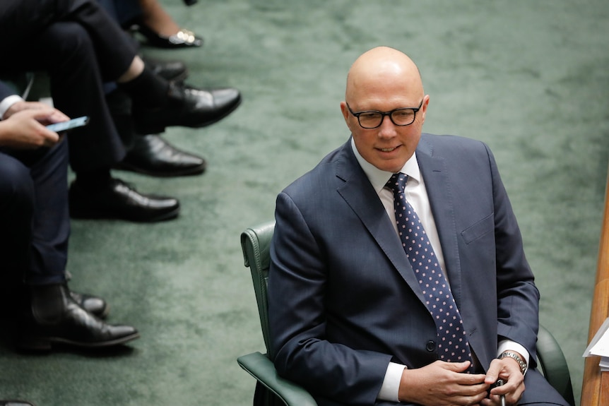 Peter Dutton sits in the House of Representatives