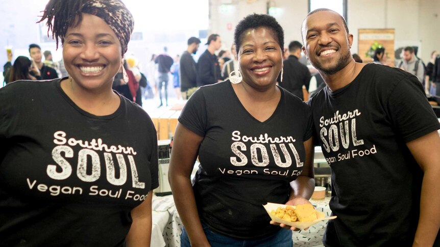 The African American family behind Southern Soul manning a stall at a market.