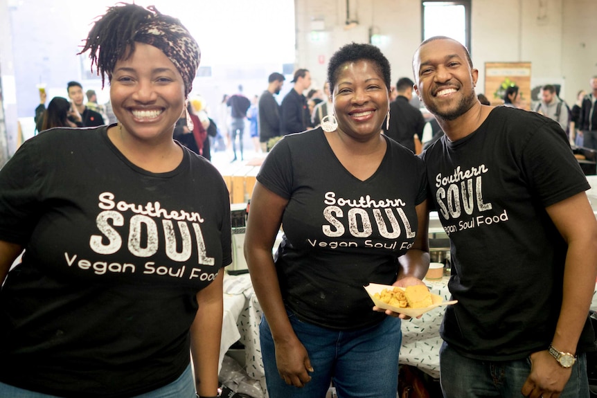 The African American family behind Southern Soul manning a stall at a market.
