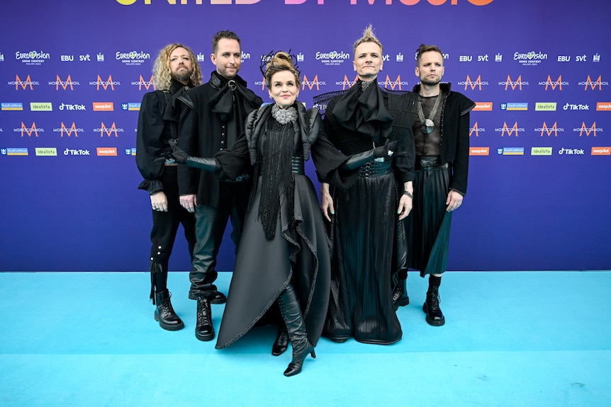 Gåte members wearing long black coats with buckles and dramatic shoulder detailing