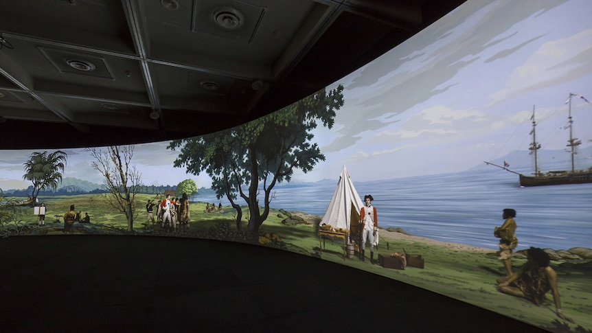 A wall projection of painted Tahitian landscape featuring filmed figures in 18th C dress re-enacting scenes from first contact.