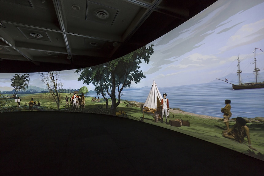 A wall projection of painted Tahitian landscape featuring filmed figures in 18th C dress re-enacting scenes from first contact.