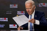 Joe Biden inspects a document