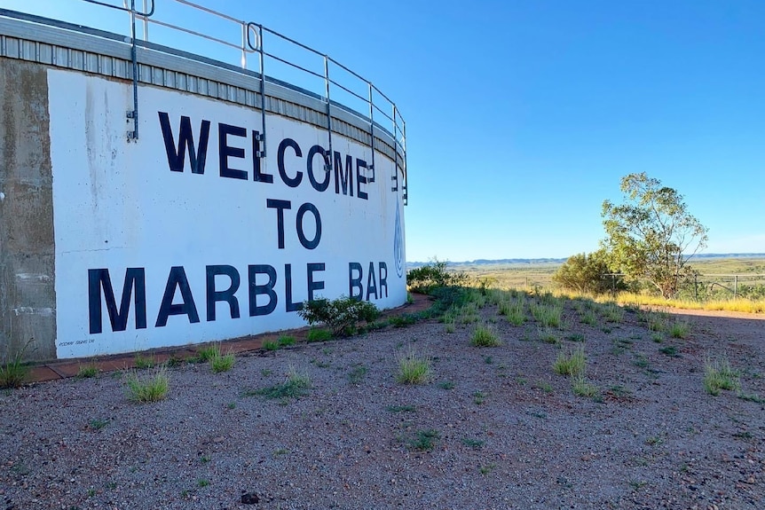 A large water tank with the words 'welcome to marble bar' written on the side. 
