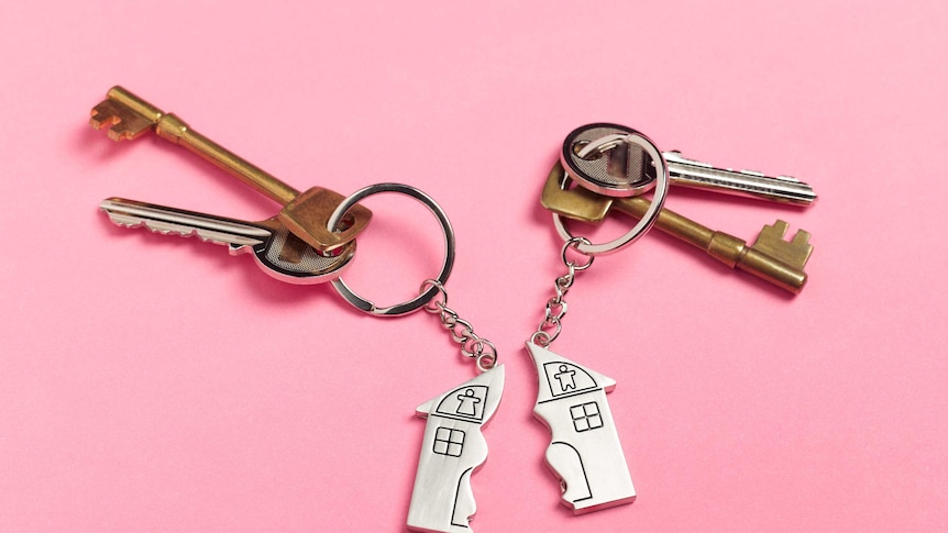Two sets of keys with half-house key chains.