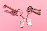 Two sets of keys with half-house key chains.