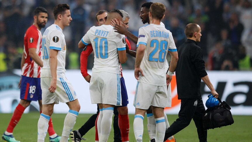 Teammates hug Marseille's Dimitri Payet (C), as he walks off injured in the Europa League final.