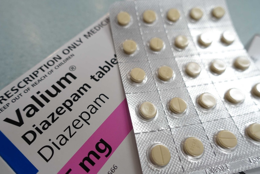 A blister pack of tablets sits on a box marked 'Valium'.