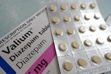 A blister pack of tablets sits on a box marked 'Valium'.