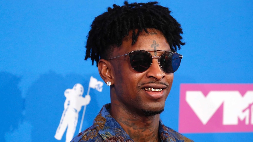 21 Savage smiles in sunglasses