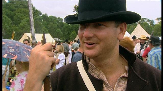 Man wears bowler hat in crowd