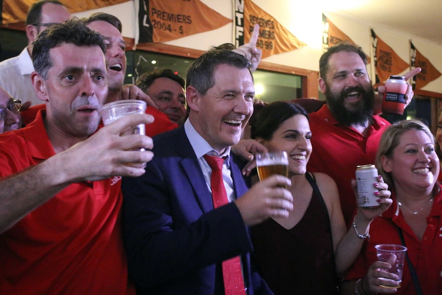 Michael Gunner bebe uma cerveja com os fiéis da festa em sua festa da vitória em Darwin.