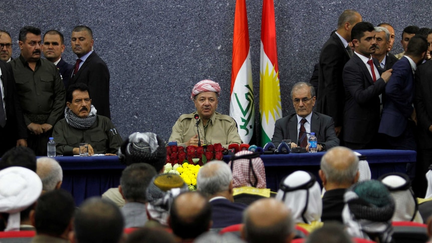 Iraqi Kurdish President Masoud Barzani sits with Kirkuk Governor Najmaldin Karim.