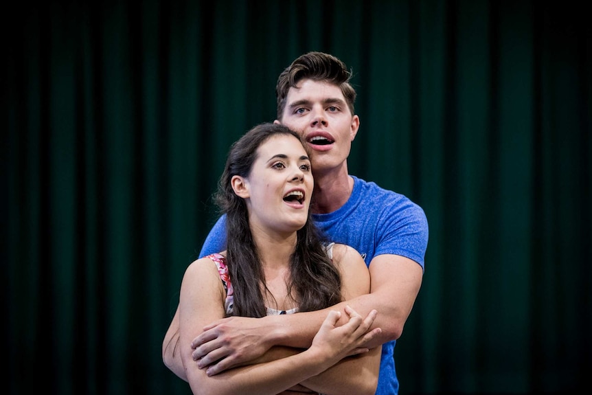Todd Jacobsson (right) who plays Tony and Sophie Salvesani as Maria sing during rehearsals for Opera Australia's West Side Story