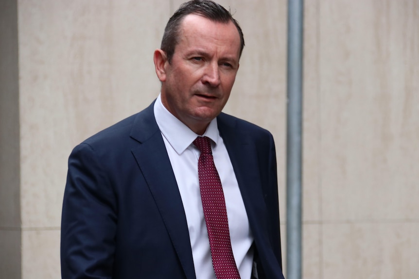 A mid shot of WA Premier Mark McGowan arriving at court wearing a suit and tie.