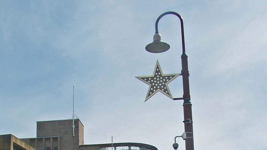 A Christmas star hangs on light pole in Hobart.