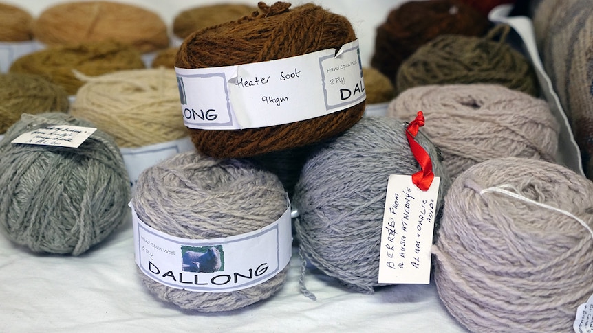 Balls of wool of various colours neatly labelled with details on how they were coloured.