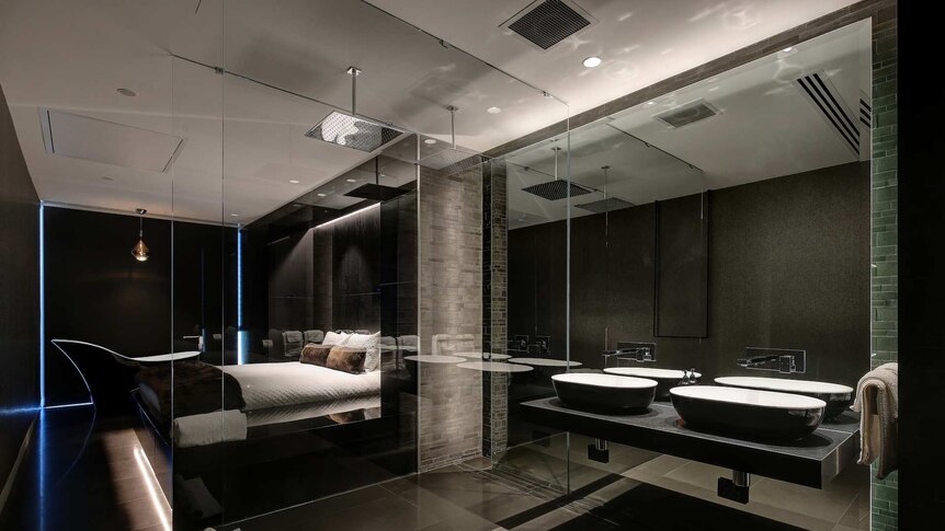 A bedroom with a bath in it