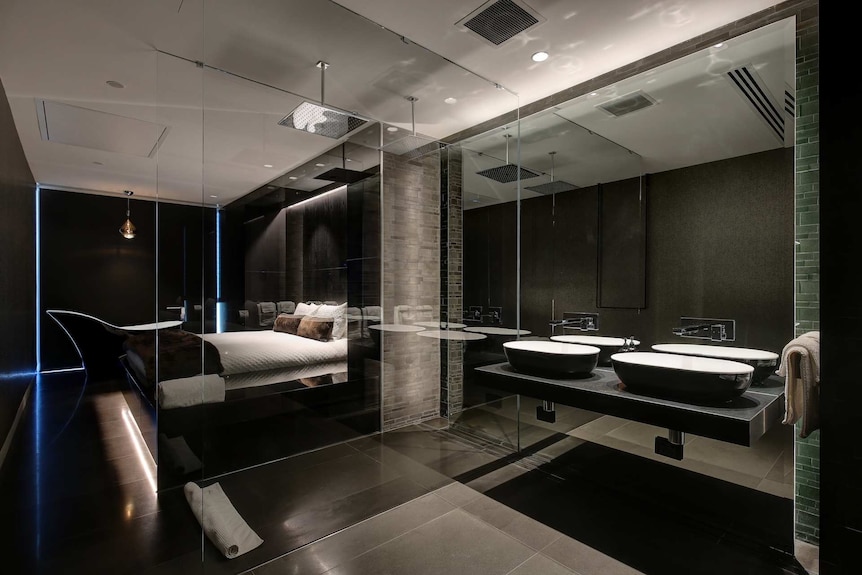 A bedroom with a bath in it
