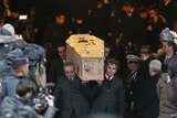 Pallbearers carry the coffin of late cartoonist Bernard Verlhac