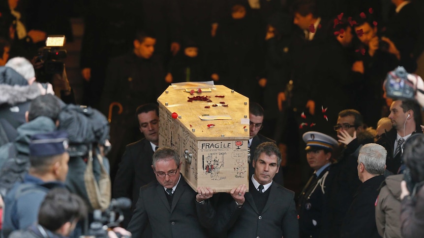 Pallbearers carry the coffin of late cartoonist Bernard Verlhac