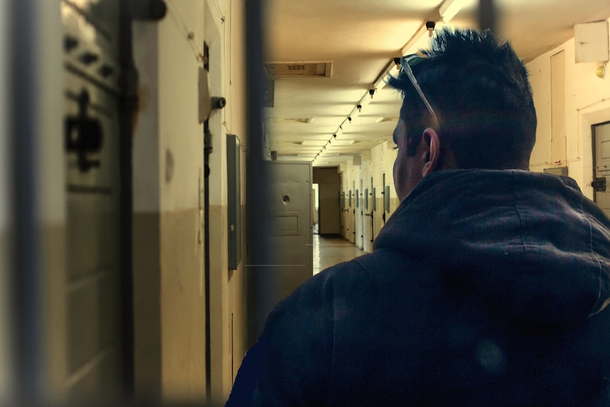 Male figure in prison hallway