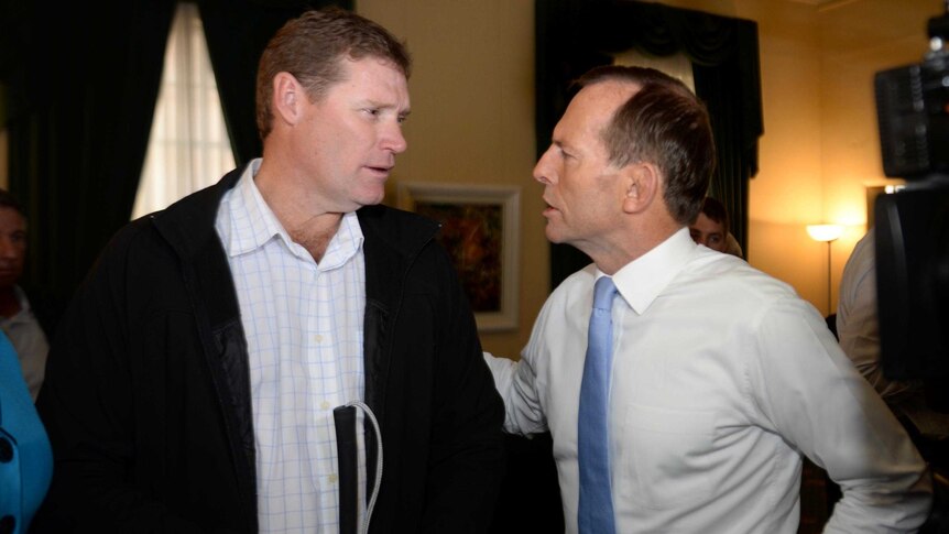 Tony Abbott speaks to Bali bombing victim Tony Purkiss.