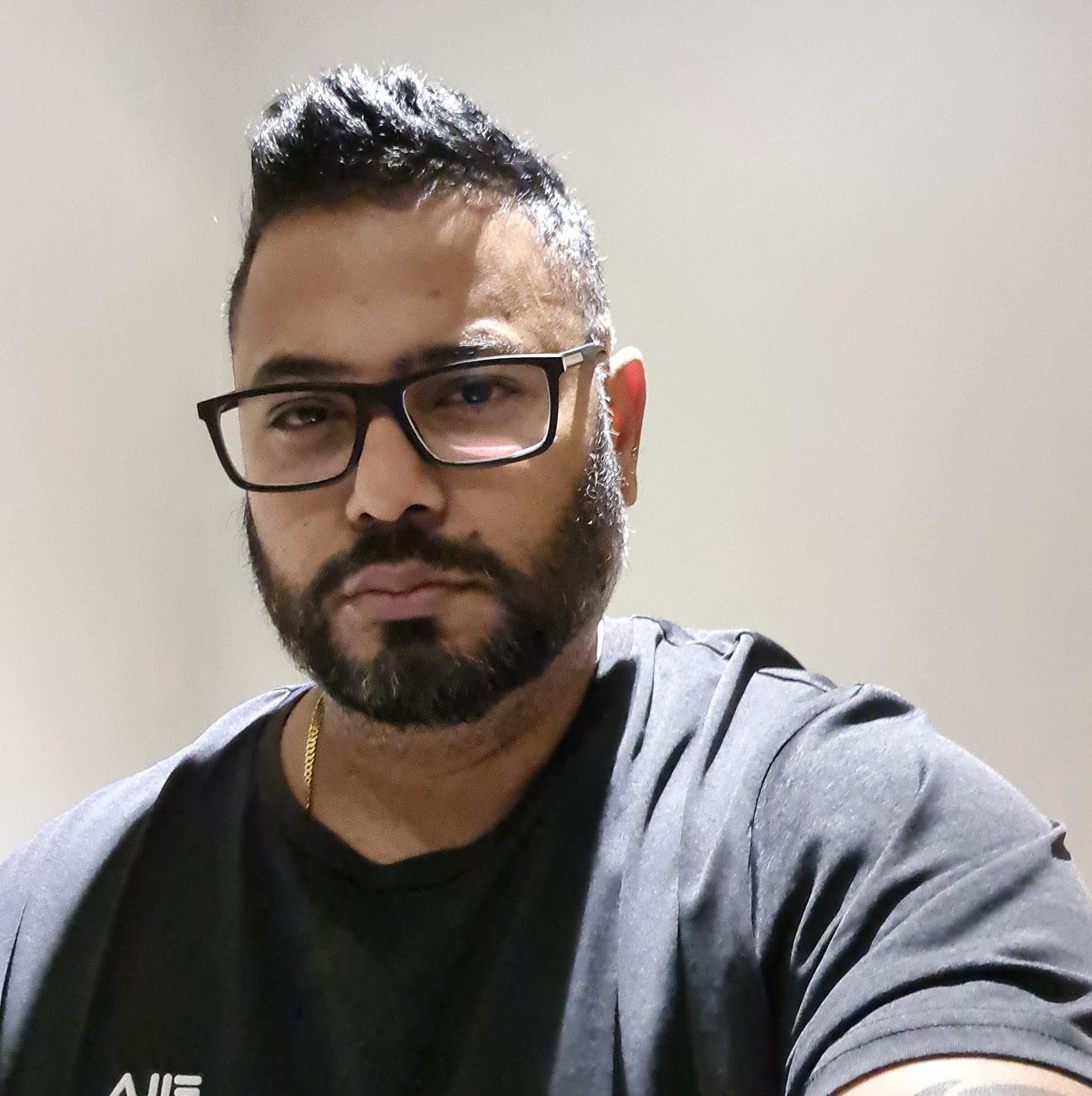 Dinush wearing glasses.