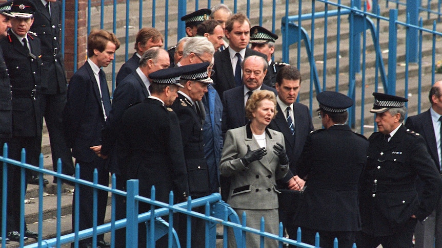 Margaret Thatcher is shown the enclosure at Hillsborough Stadium.