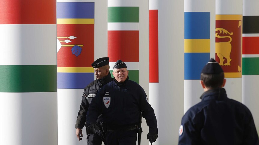 Paris police patrol entrance of COP21 venue